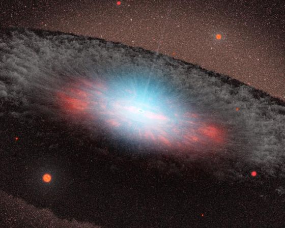 这张艺术示意图展示的是位于一个星系核心的超大质量黑洞。图像中蓝色表示的是在非常接近星系核心的区域正在向外扩散的辐射；图像中包围黑洞周围的褐色结构被称作“环面”，由大量的气体和尘埃组成