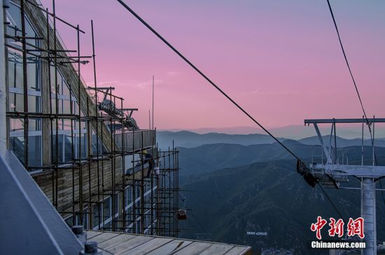 图为夏季傍晚时分,工人正在修缮崇礼区万龙滑雪场建筑。 图为夏季傍晚时分,工人正在修缮崇礼区万龙滑雪场建筑。