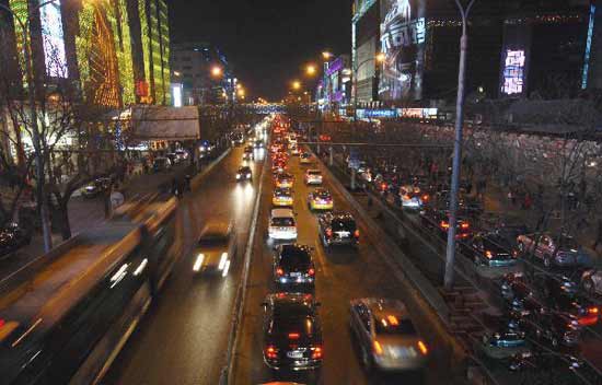 12月12日晚，北京西单大街路边停满机动车，主路由南向北方向行驶缓慢。新华社发（张宇 摄）