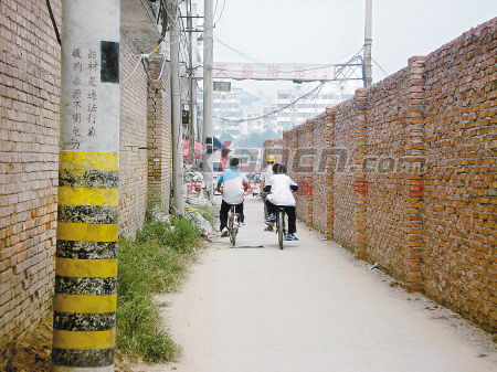 工地围墙占大半路面 高铁寨小学孩子上学路难