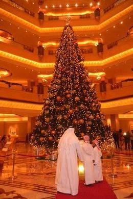 The 13-metre (40-foot) faux evergreen, located in the gold leaf-bedecked rotunda of the hotel, is decorated with silver and gold bows, ball-shaped ornaments and small white lights.