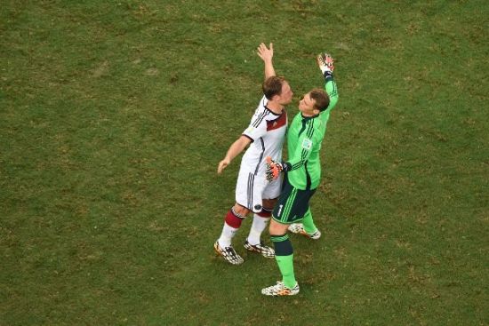 German goalie Manuel Neuer chest bumps teammate
