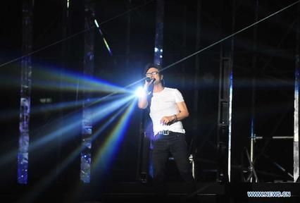 Chinese singer Wang Feng performs at his solo concert in Beijing, Aug 2, 2014. [Photo/Xinhua]