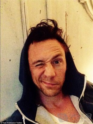 We can tell it's you! Actor Tom Hiddleston covered his bed hair with a hoody.
