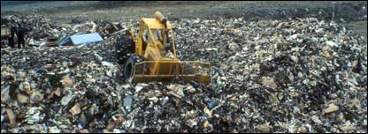 A digger on a landfill site