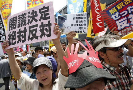 Protesters in front of Japanese Prime Minister Shinzo Abe's official residence in Tokyo shout slogans at a rally on Tuesday against his push to expand the nation's military role. Yuya Shino / Reuters 