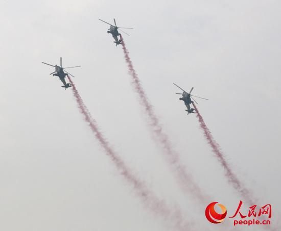 直-10武装直升机正在表演“三机跃升倒转”特技动作。