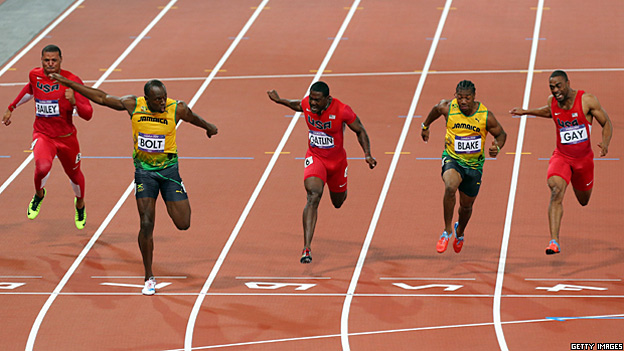 Usain Bolt crosses the finish line in the men's 100m final