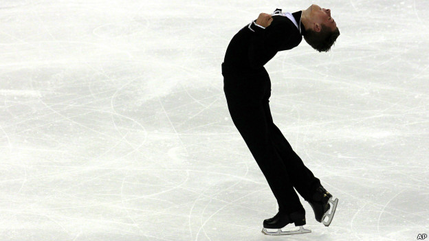 An ice skater performs a move in which he bends backwardsam Guards, Getty Images