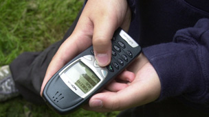 A teenager using a mobile phone