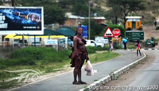 Enter the Opuwo Town, beer advertising giant, stands a bare-chested red woman, Zimbabweans, we finally meet with them