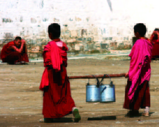 Two monks carry water to drink