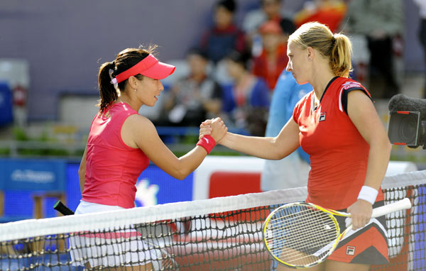Svetlana Kuznetsova of Russia returns a shot to Zheng Jie of China