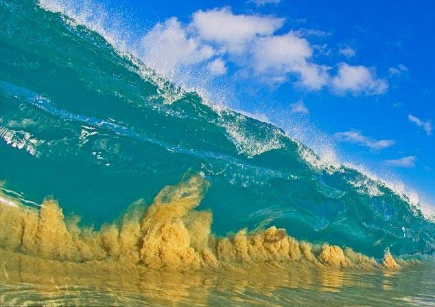 一股巨大的海浪开始冲击沙滩,金色的沙粒被自上而下的搅动,无休止地