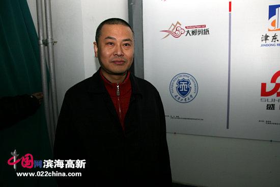 天津工业大学艺术与服装学院教授张立教授在其设计的作品前.