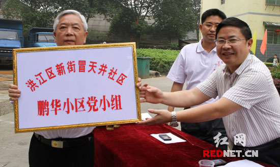 (洪江区工委组织部部长为该小区党小组授牌)