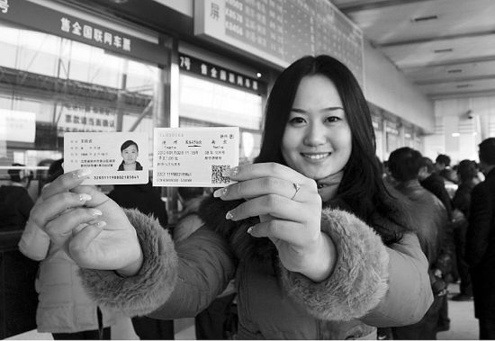 2012年1月1日,一名旅客在扬州火车站售票大厅内展示自己的身份证和